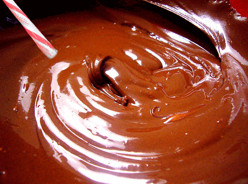 Image of chocolate pudding with a candy cane sticking out of it